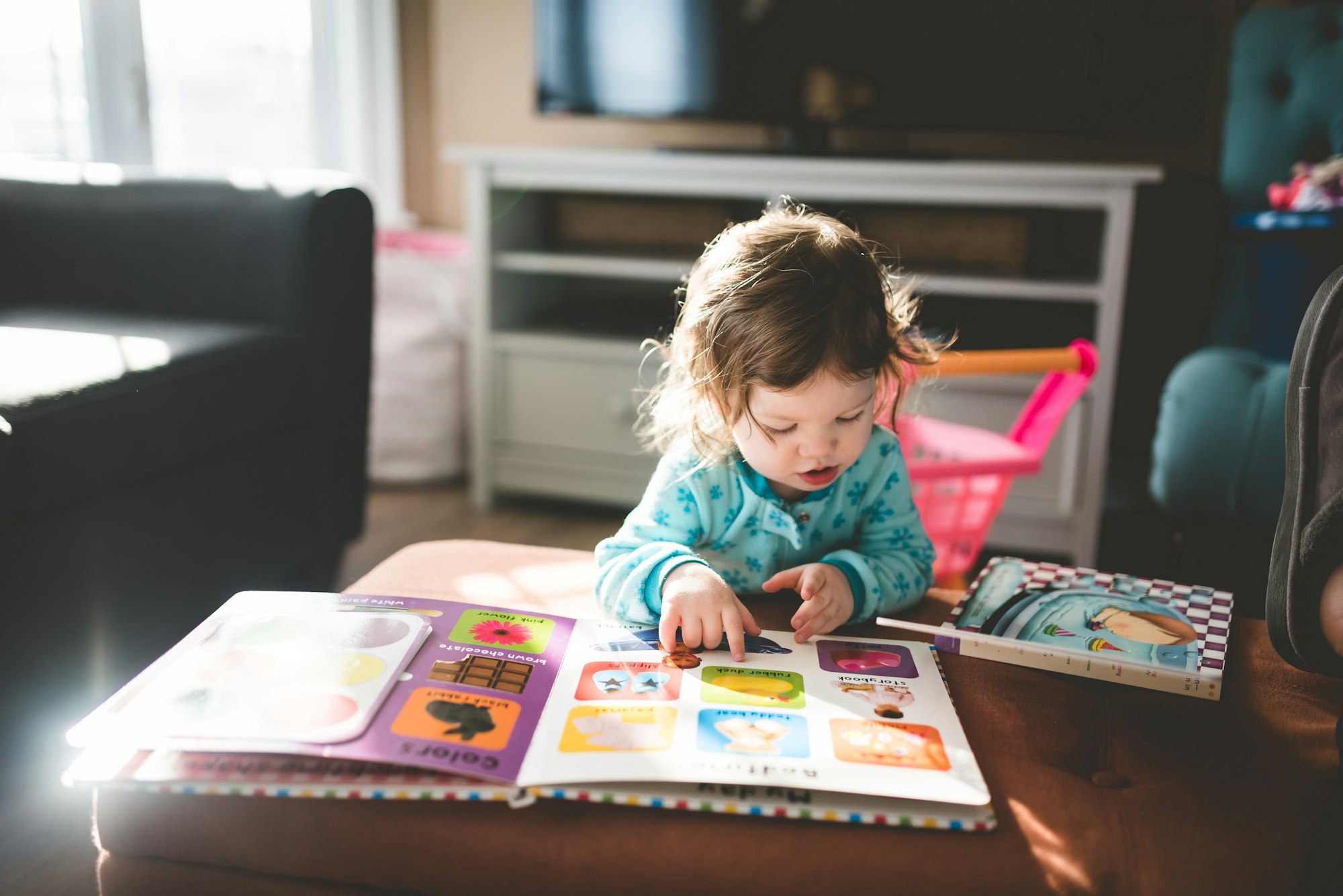 Petite fille découvrant un livre illustré